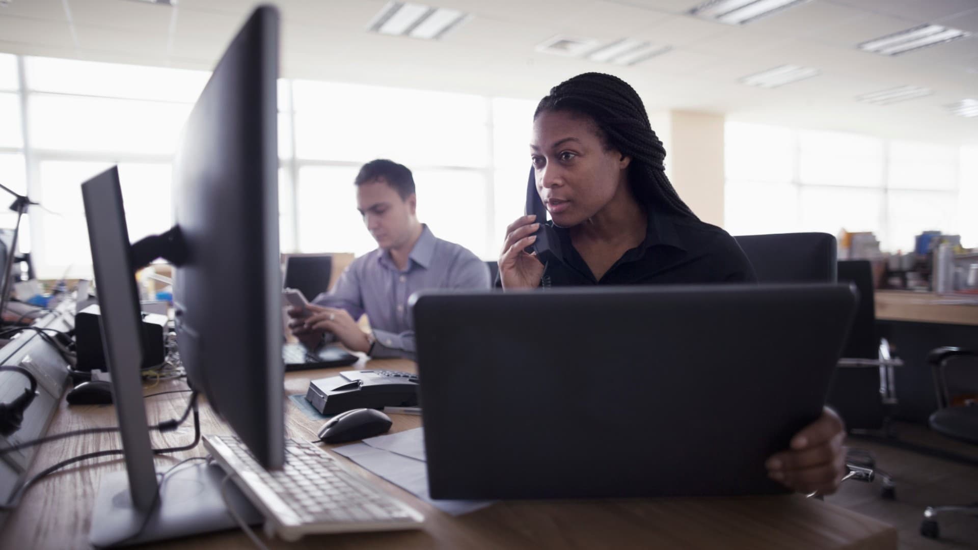 A computer support professional helping a caller.